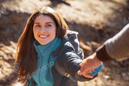 Preview: Portrait of happy young woman outstretching hand to man