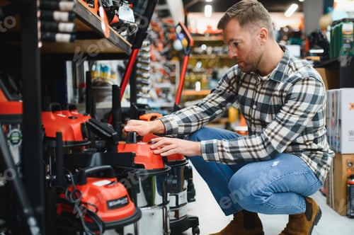 Preview: A man in a hardware store choosing a tool