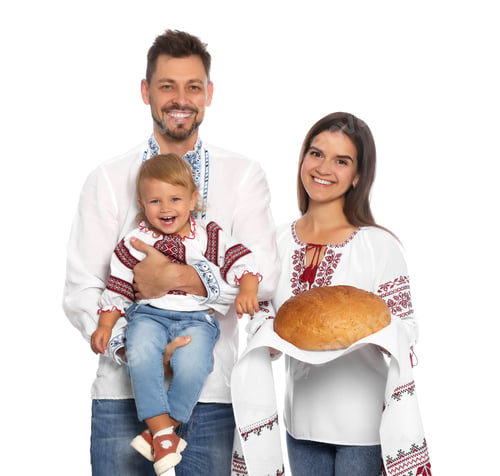Preview: Happy Ukrainian family in embroidered shirts with korovai bread on white background