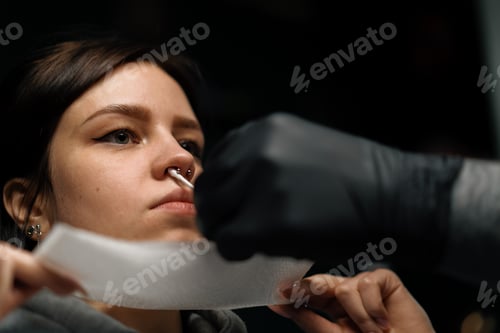 Preview: Piercing studio nose piercing for girl after the procedure the master processes septum