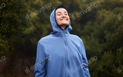 Preview: Nature, happiness and woman with raincoat, smile and wellness standing in outdoor park. Peace, calm