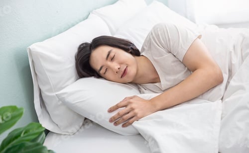 Preview: Portrait of handsome young asian man with enjoy fresh soft bedding linen mattress in white bed room