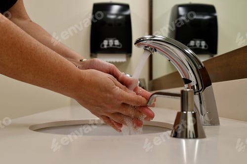 Preview: Washing hands in a public restroom, bathroom. Stop the spread of germs, sickness, colds and illness.