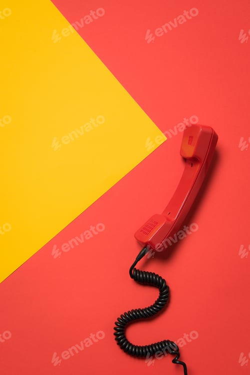 Preview: Close-up view of red telephone receiver with curly cord, communication concept