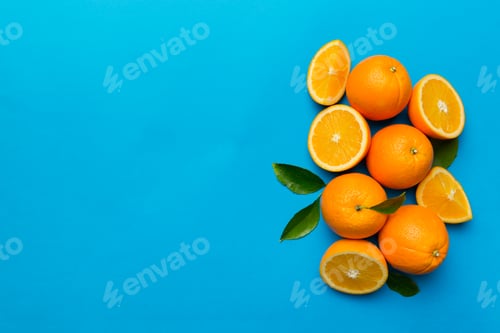 Preview: fresh Fruit orange slices on colored background. Top view. Copy Space.