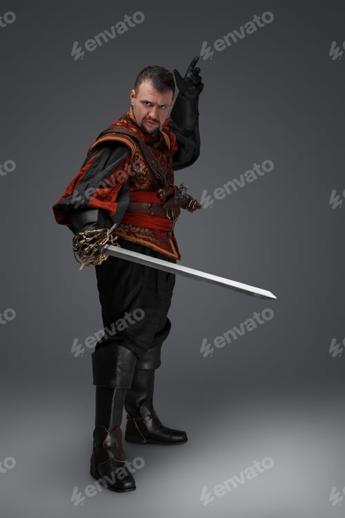 Preview: Conquistador with sword dressed in stylish red costume