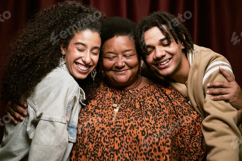 Preview: Portrait of Middle Aged Black Woman Hugging Two Young Adult Multiethnic Friends