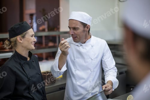 Preview: Chefs chatting and tasting food in kitchen
