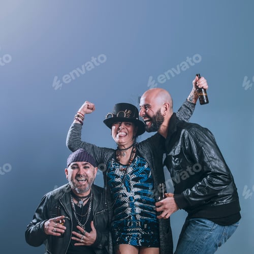 Preview: alternative friends with beer in hand laugh with joyful expression in studio shot