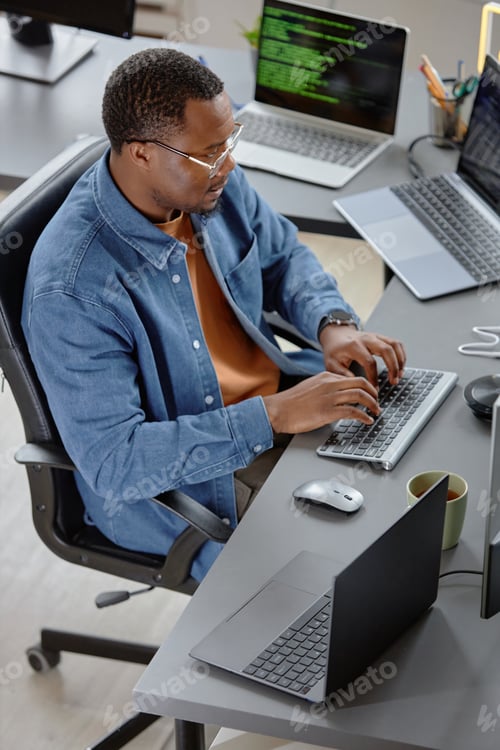 Preview: Young Male IT Engineer In Glasses Using Computer