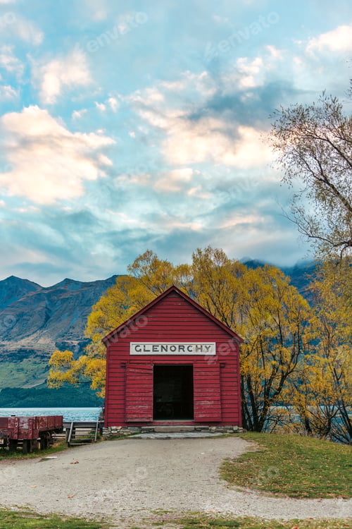 Preview: Scenic Glenorchy boat shed by Lake Wakatipu with colorful autumn foliage and mountai