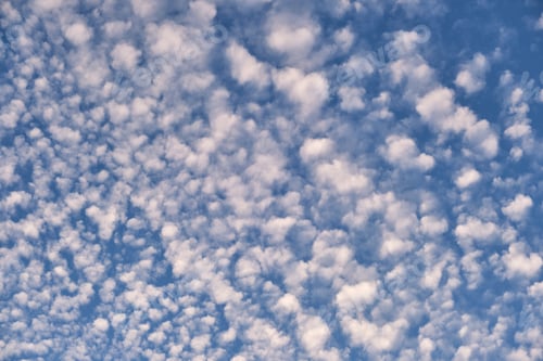 Preview: Bright landscape of white puffy clouds spread on blue clear sky