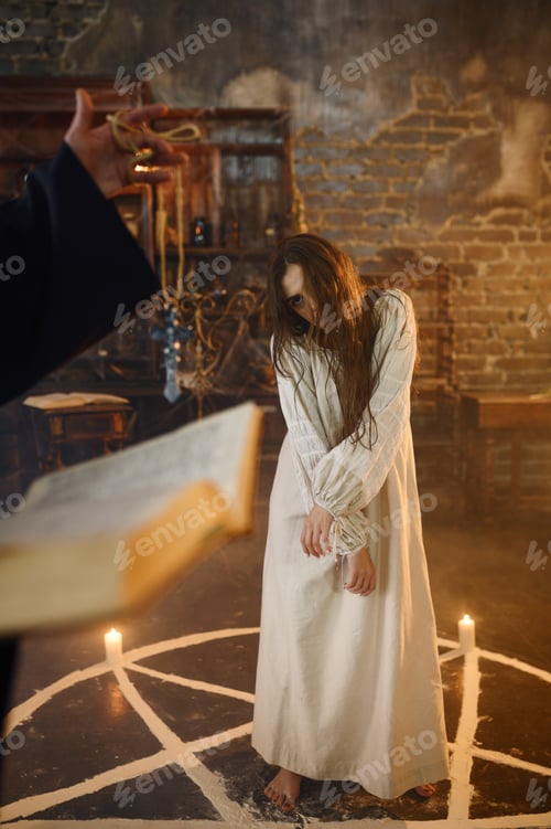 Preview: Exorcist in hood casting out demons from a woman