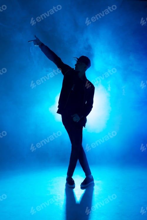 Preview: Professional male dancer dancing in night club with smoke and blue neon lights