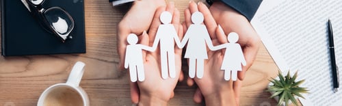 Preview: panoramic crop of lawyer and woman holding paper cut family near cup, insurance agreement, notebook
