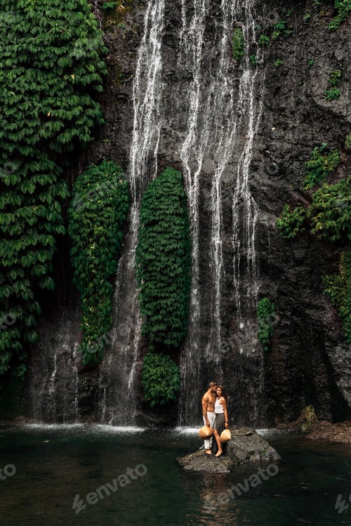 Preview: A couple in love on a waterfall. Honeymoon trip. Happy couple on the island of Bali.
