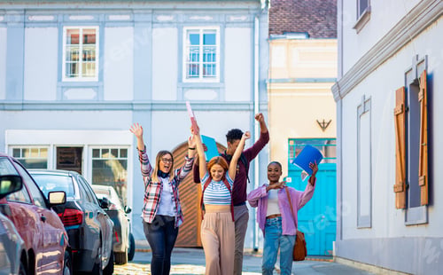 Preview: Excited group of students is walking down the street, overjoyed at the end of their studies.