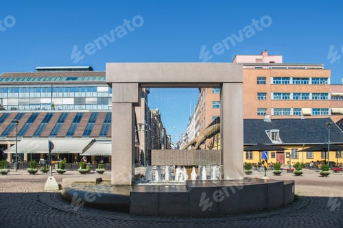 Preview: OSLO, NORWAY - 28 JULY, 2018: Fountain shaped like hand on square with beautiful architecture in
