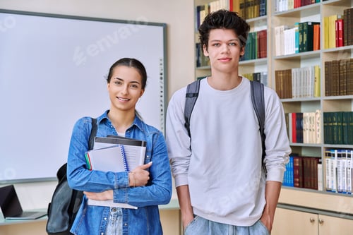 Preview: Portrait of two teenage college students, guy and girl, inside library of educational building