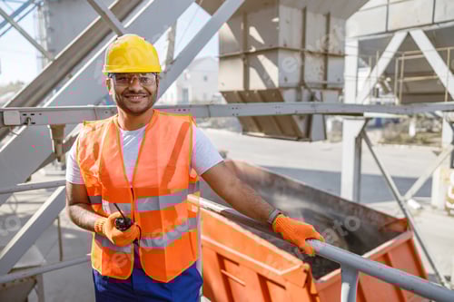Preview: Smiling young construction engineer working in plant