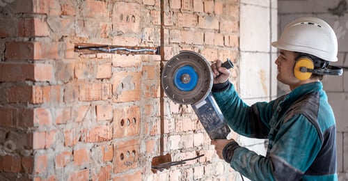 Preview: A handyman at a construction site works as a grinder.