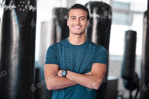 Preview: Portrait, punching bag with a man boxer in the gym, standing arms crossed for fitness or motivation