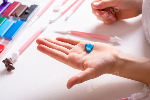 Preview: Detail for a product made of polymer clay in children's hands. Handmade and leisure.