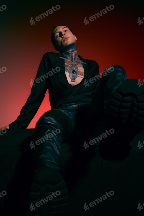 Preview: Stylish young man showcasing modern fashion trends in a striking artistic setting