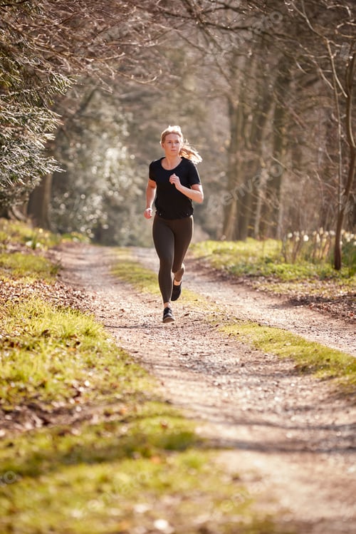 Preview: Young Woman Running In Autumn Countryside To Improve Mental Health During Health Lockdown