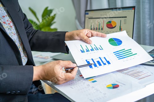 Preview: Asian accountant working and analyzing financial reports project accounting with chart graph