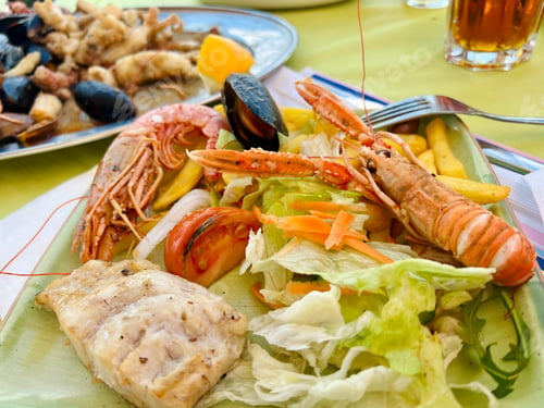 Preview: Grilled shrimps and mussels with salad on a plate