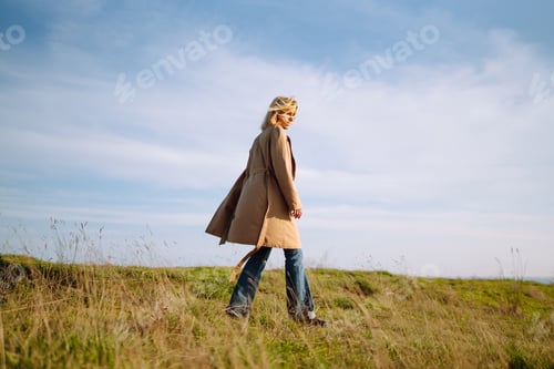 Preview: Young woman enjoys a spring sunny day. People, lifestyle, travel, nature and vacations concept.