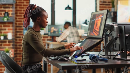 Preview: African american woman designing game interface on computer