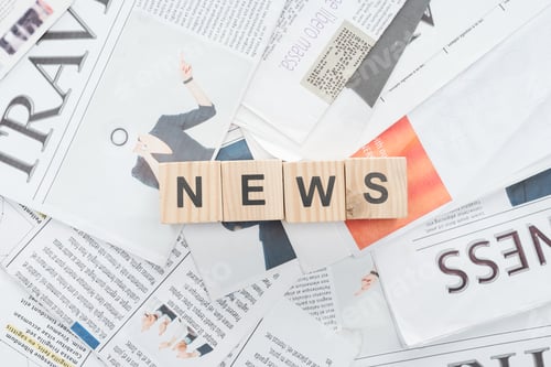 Preview: top view of wooden cubes with word news on newspapers