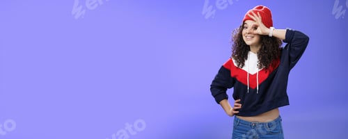 Preview: Okay girl agrees. Friendly-looking happy and charming young curly-haired girl in warm beanie