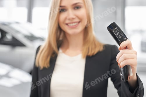 Preview: Car dealer holding car keys, smiling, posing