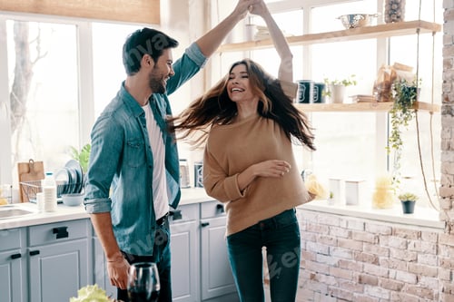 Happy Couple Dancing Together in Their Sunny Kitchen