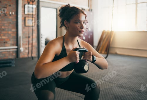 Preview: Fitness, kettlebell and a woman at gym doing workout, exercise and weight training for body wellnes