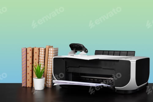 Preview: Home laser printer on desk against green background