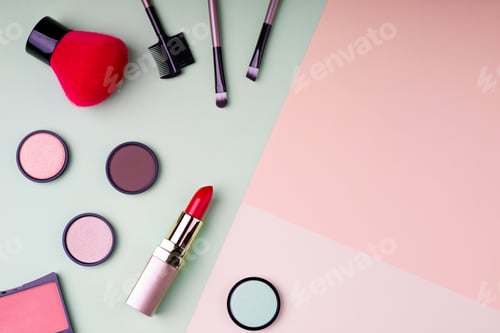 Preview: Makeup products and decorative cosmetics on color background flat lay. Fashion and beauty
