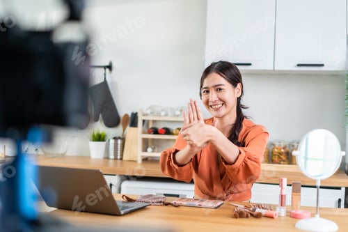 Preview: Asian female vlogger talk with camera to review the cosmetic at home.
