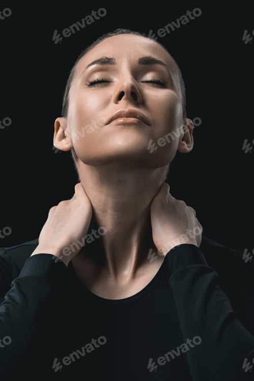 Preview: tired young fitness woman stretching neck isolated on black.