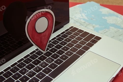 Preview: gps location sign on laptop, map on tabletop