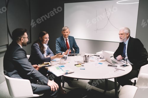 Preview: Group of colleagues discussing business strategy in conference room