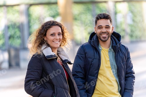 Preview: Happy couple smiling outdoors in the city during winter