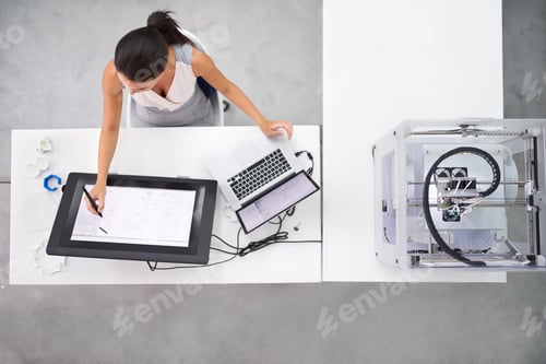 Preview: Printing has just gone 3D. Cropped shot of an attractive young woman working beside a 3D printer.
