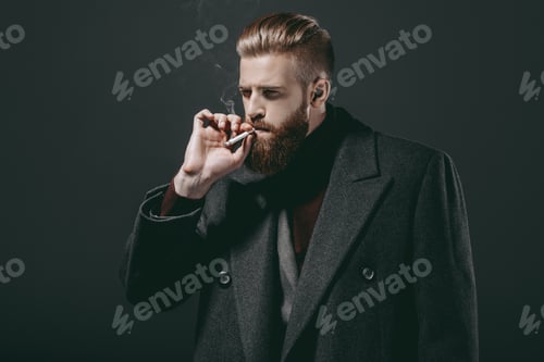 Preview: portrait of stylish man in jacket smoking cigarette isolated on black