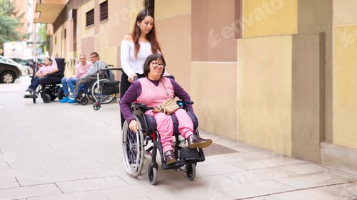 Preview: Caregiver assisting woman in wheelchair promoting inclusion and diversity