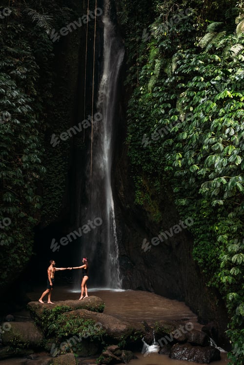 Preview: A couple in love on a waterfall. Honeymoon trip. Beautiful couple at a waterfall in Bali