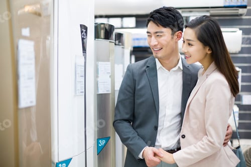 Preview: Young couple buying air conditioner in electronics store
